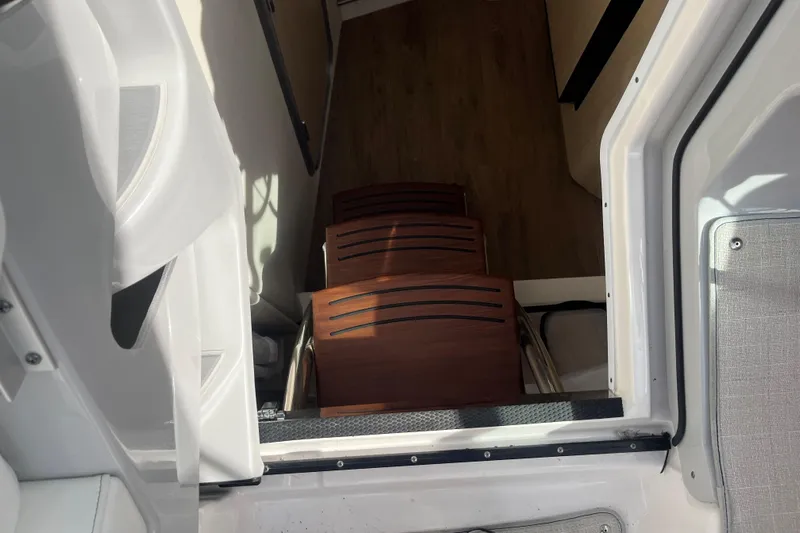 Yacht Photos Pics 2023 Regal 28 Express cabin entrance with wooden steps and modern interior.