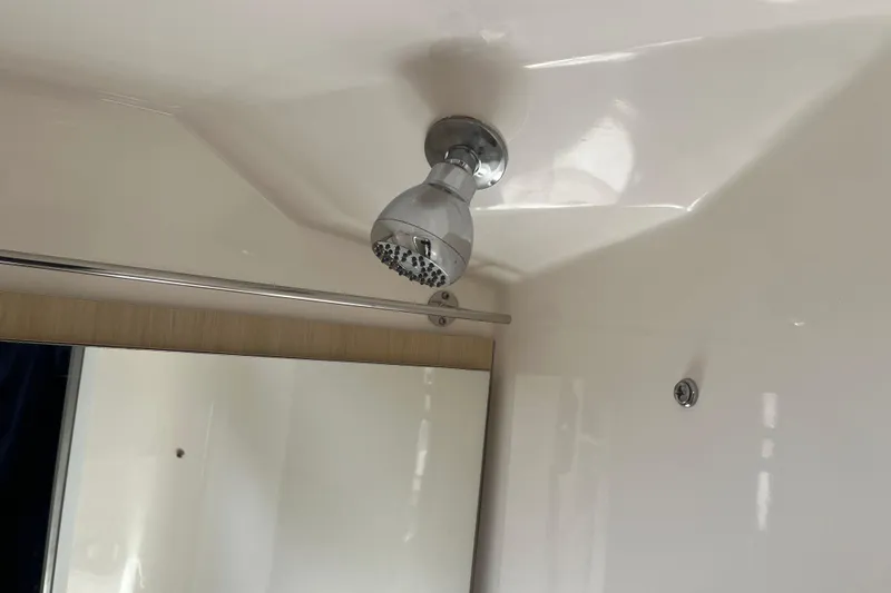  Yacht Photos Pics Shower area in 2023 Regal 28 Express boat, featuring a modern showerhead.