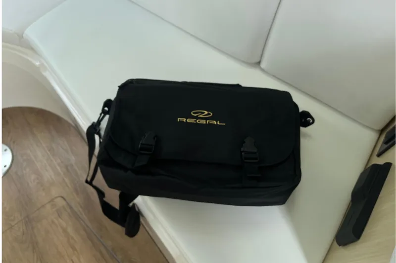  Yacht Photos Pics Black Regal bag on a white seat inside a 2023 Regal 28 Express boat.
