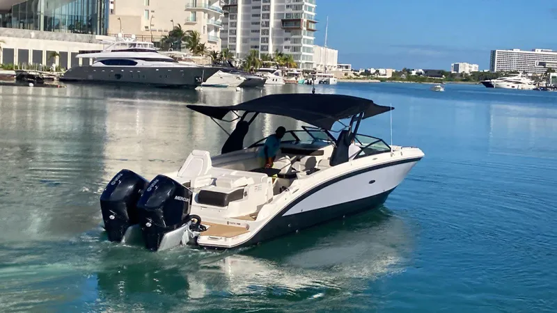 2020 Sea Ray 290 Sdx Ob Yacht Photos Pics 2020 Sea Ray SDX 290 Outboard cruising in a marina with modern buildings.
