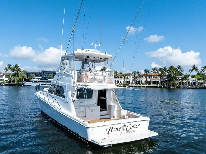  Yacht Photos Pics 2001 Riviera 48 yacht cruising on a sunny day near waterfront homes.