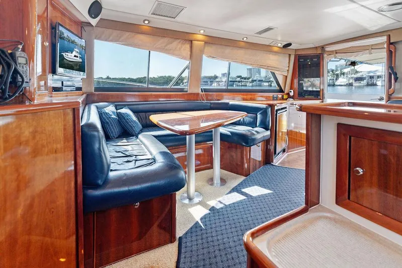  Yacht Photos Pics Luxurious 2001 Riviera 48 yacht interior with elegant wood finish and comfortable seating.