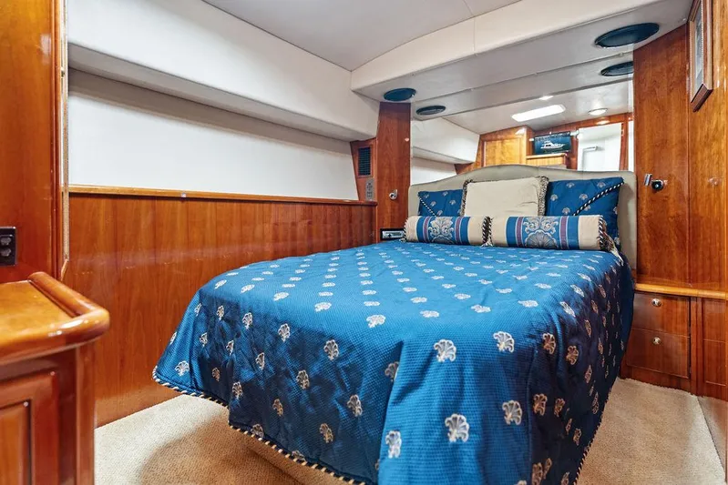  Yacht Photos Pics Luxurious cabin interior of a 2001 Riviera 48 yacht with elegant bedding.