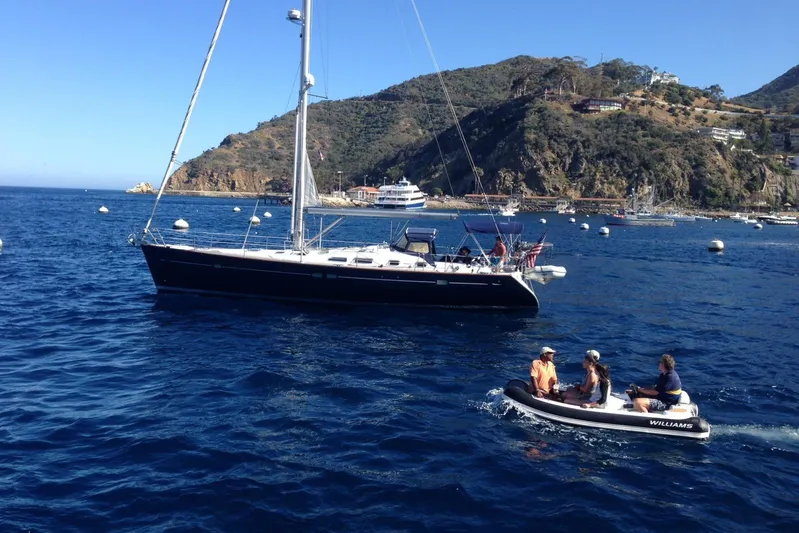 Dionysus Yacht Photos Pics Sailboat Beneteau Oceanis Clipper 473, 2003 model, anchored near scenic coastal cliffs.