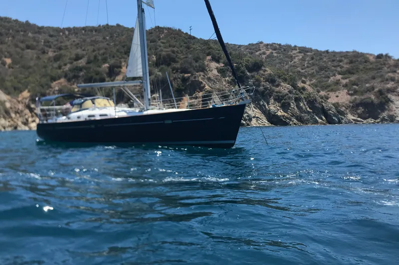 Dionysus Yacht Photos Pics Sailboat Beneteau Oceanis Clipper 473, 2003, anchored near rocky coastline.