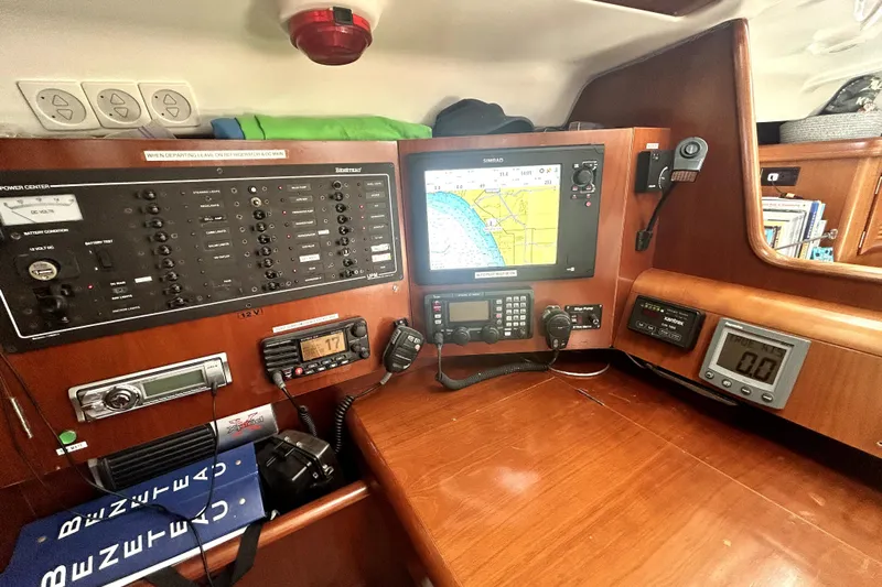 Dionysus Yacht Photos Pics Navigation station of 2003 Beneteau Oceanis Clipper 473 with control panels and electronic displays.