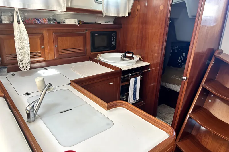 Dionysus Yacht Photos Pics Interior of 2003 Beneteau Oceanis Clipper 473 yacht, featuring a compact kitchen area.