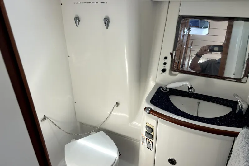 Dionysus Yacht Photos Pics Bathroom interior of 2003 Beneteau Oceanis Clipper 473 yacht, featuring toilet and sink.