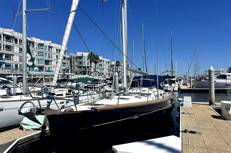 Dionysus Yacht Photos Pics Beneteau Oceanis Clipper 473 sailboat docked at marina, 2003 model, sunny day.