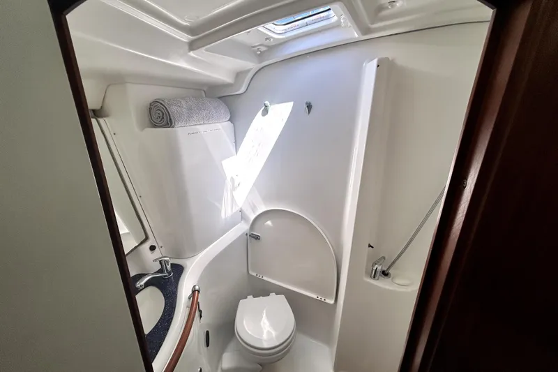 Dionysus Yacht Photos Pics Bathroom interior of 2003 Beneteau Oceanis Clipper 473 yacht, featuring toilet and sink.