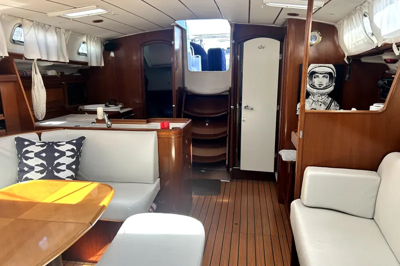 Dionysus Yacht Photos Pics Interior of 2003 Beneteau Oceanis Clipper 473 yacht with wood finish and cozy seating area.