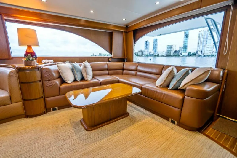 Last Call Yacht Photos Pics Luxurious interior of 2011 Viking 70 Enclosed Bridge yacht with leather seating and city view.