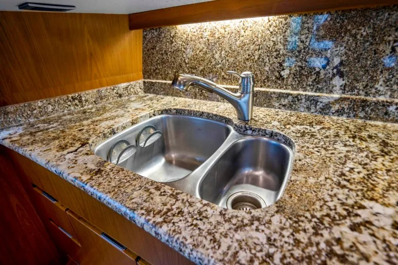 Last Call Yacht Photos Pics Granite countertop with double sink in 2011 Viking 70 Enclosed Bridge yacht kitchen.