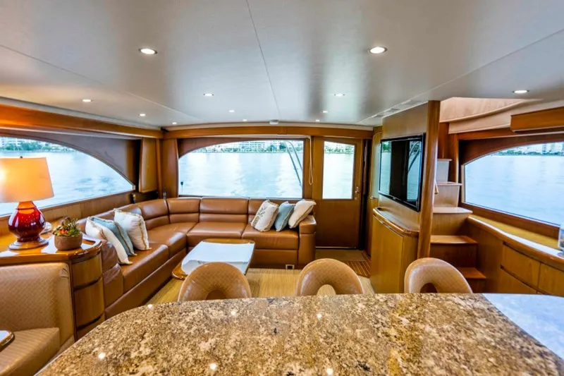 Last Call Yacht Photos Pics Luxurious interior of 2011 Viking 70 Enclosed Bridge yacht with elegant seating and panoramic windows.