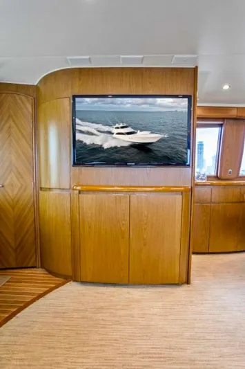Last Call Yacht Photos Pics Interior of 2011 Viking 70 Enclosed Bridge yacht with wooden paneling and mounted TV.