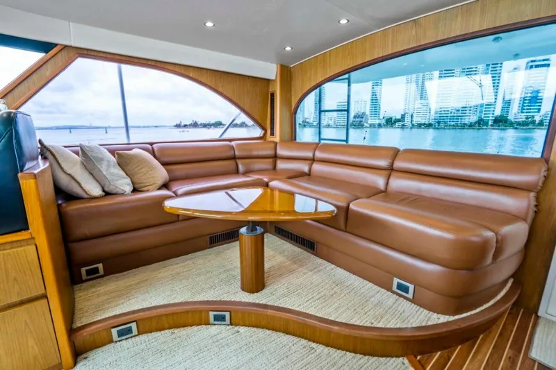 Last Call Yacht Photos Pics Luxurious interior of 2011 Viking 70 Enclosed Bridge yacht with leather seating and ocean view.