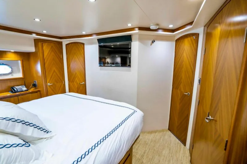 Last Call Yacht Photos Pics Luxurious bedroom interior of 2011 Viking 70 Enclosed Bridge yacht with wood accents.