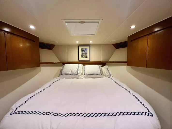 Last Call Yacht Photos Pics Luxurious bedroom interior of 2011 Viking 70 Enclosed Bridge yacht with elegant bedding.