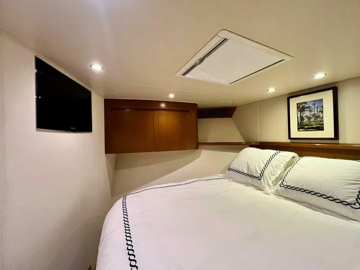 Last Call Yacht Photos Pics Luxurious cabin interior of 2011 Viking 70 Enclosed Bridge yacht with cozy bedding.