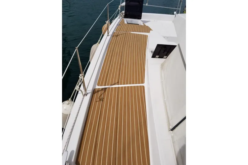  Yacht Photos Pics Deck of 2016 Bali 4.0 catamaran with teak flooring, docked on calm water.