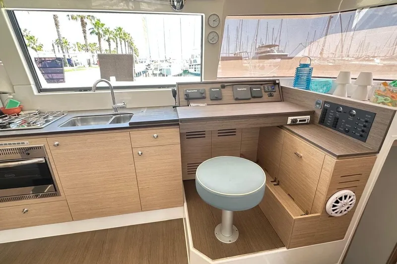  Yacht Photos Pics Interior of 2016 Bali 4.0 catamaran with modern kitchen and navigation station.