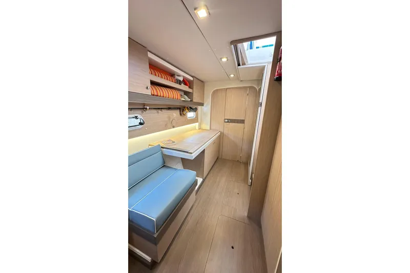  Yacht Photos Pics Interior of 2016 Bali 4.0 catamaran with seating, table, and storage shelves.