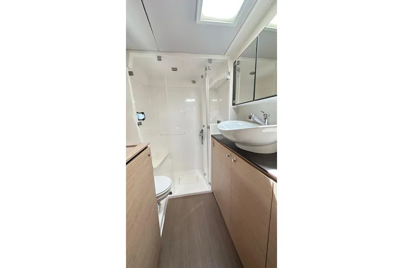  Yacht Photos Pics Modern bathroom interior of 2016 Bali Catamarans Bali 4.0 with sleek fixtures and wood accents.