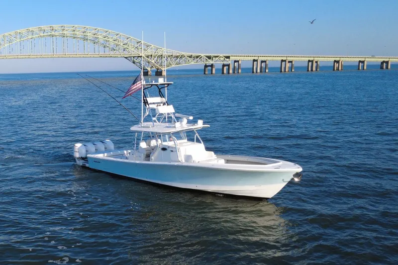  Yacht Photos Pics 2016 Regulator 41 boat cruising near a bridge on a sunny day.