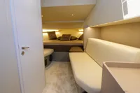 Luxurious interior of 2021 Seanfinity T5 yacht with cozy seating and elegant bedding.