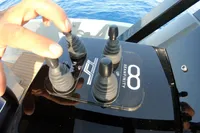 Control panel of a 2021 Seanfinity T5 boat with hand adjusting levers.