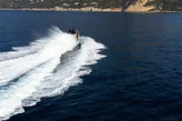 Seanfinity T5 boat speeding on open water, creating a dynamic wake, 2021 model.