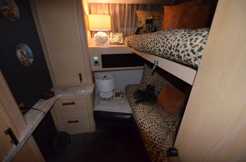 Suite Forty Six Yacht Photos Pics 1989 Silverton Aft Cabin 46 interior with leopard print bedding and cozy lighting.