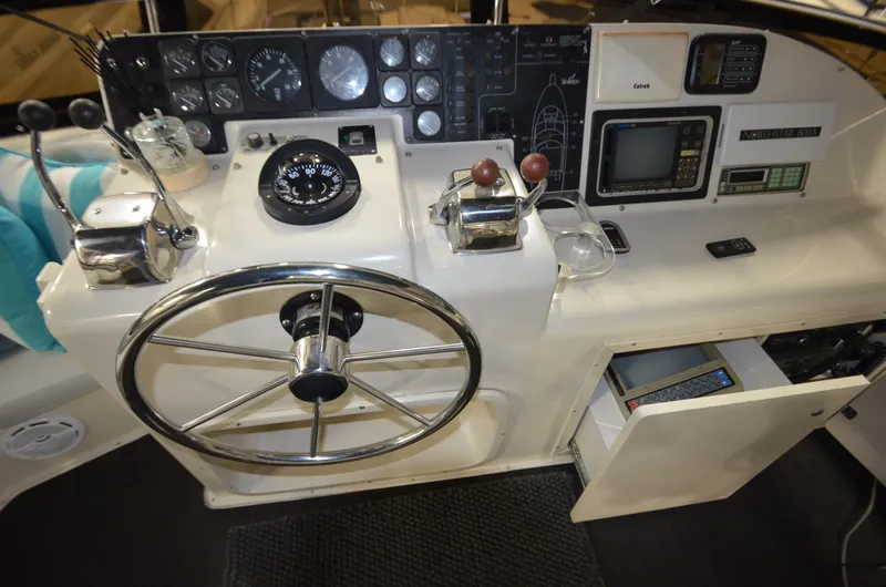 Suite Forty Six Yacht Photos Pics 1989 Silverton Aft Cabin 46 helm with steering wheel and navigation instruments.