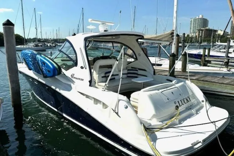  Yacht Photos Pics 2003 Sea Ray 420 Sundancer yacht docked, featuring sleek design and paddleboards on deck.