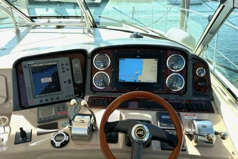  Yacht Photos Pics 2003 Sea Ray 420 Sundancer helm with navigation instruments and steering wheel.