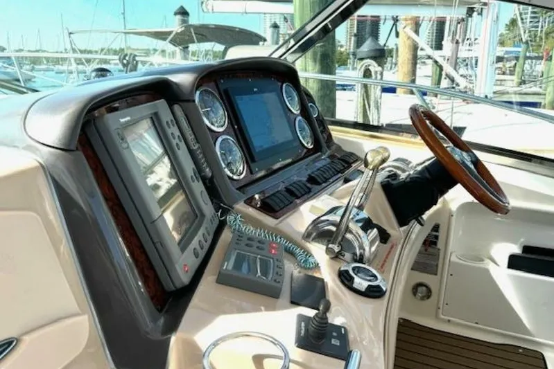  Yacht Photos Pics Cockpit of 2003 Sea Ray 420 Sundancer with navigation equipment and steering wheel.