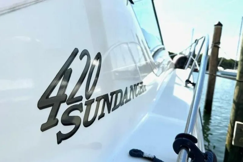  Yacht Photos Pics 2003 Sea Ray 420 Sundancer yacht docked, showcasing sleek design and branding.