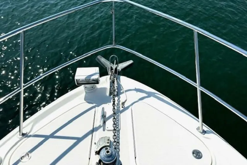  Yacht Photos Pics Bow of 2003 Sea Ray 420 Sundancer yacht with anchor and railing over water.