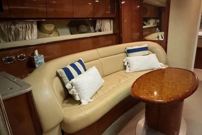 Yacht Photos Pics Luxurious interior of 2003 Sea Ray 420 Sundancer with plush seating and elegant wood table.