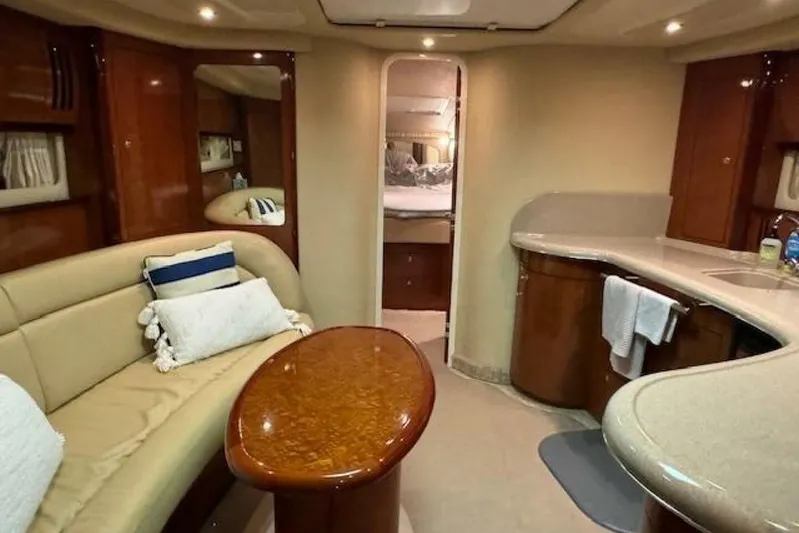  Yacht Photos Pics Luxurious interior of 2003 Sea Ray 420 Sundancer yacht with elegant seating and kitchenette.