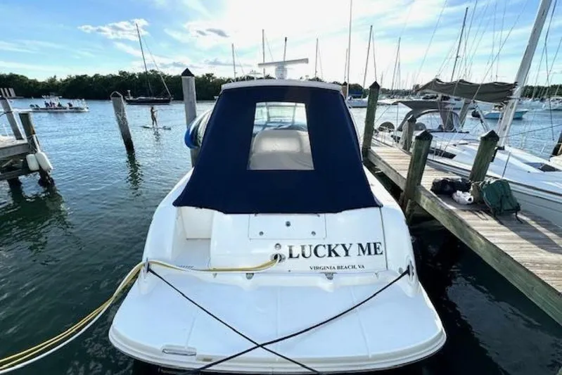  Yacht Photos Pics 2003 Sea Ray 420 Sundancer docked, rear view with "Lucky Me" name visible.