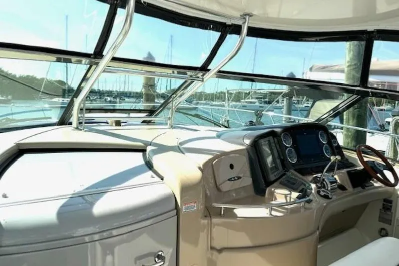  Yacht Photos Pics 2003 Sea Ray 420 Sundancer helm with modern controls and marina view.
