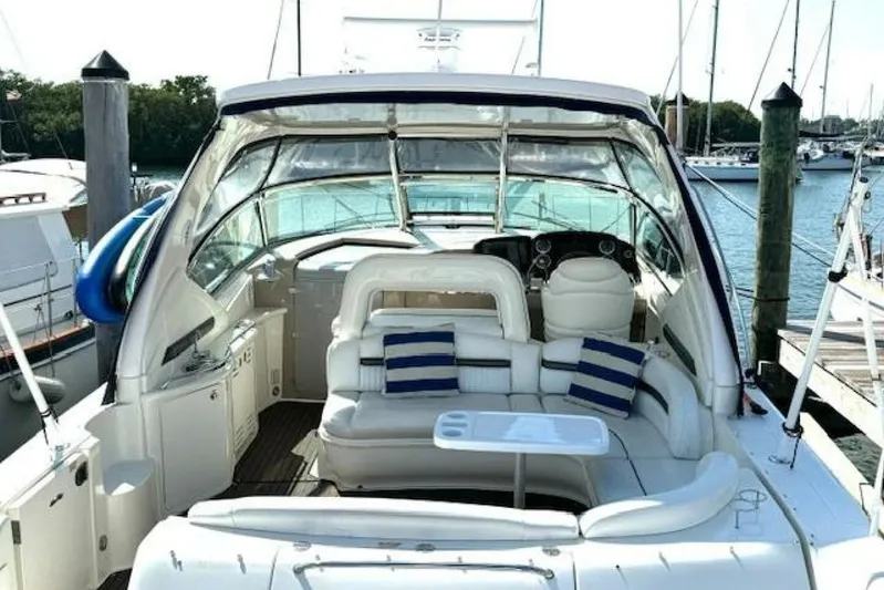  Yacht Photos Pics 2003 Sea Ray 420 Sundancer yacht interior with white seating and striped cushions at a marina.