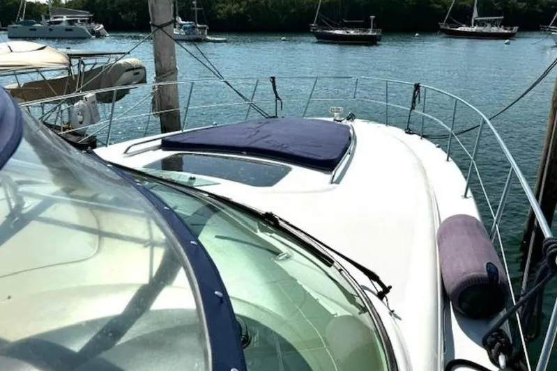  Yacht Photos Pics 2003 Sea Ray 420 Sundancer yacht docked, with scenic water and boats in the background.