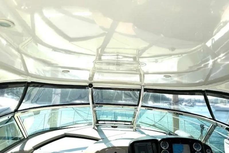  Yacht Photos Pics Interior view of 2003 Sea Ray 420 Sundancer yacht cockpit with clear windows and control panel.