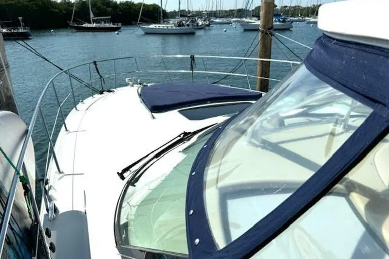  Yacht Photos Pics 2003 Sea Ray 420 Sundancer yacht docked in a marina with other boats.