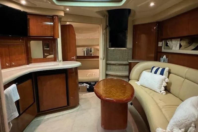  Yacht Photos Pics Interior of 2003 Sea Ray 420 Sundancer yacht with elegant wood finishes and cozy seating.