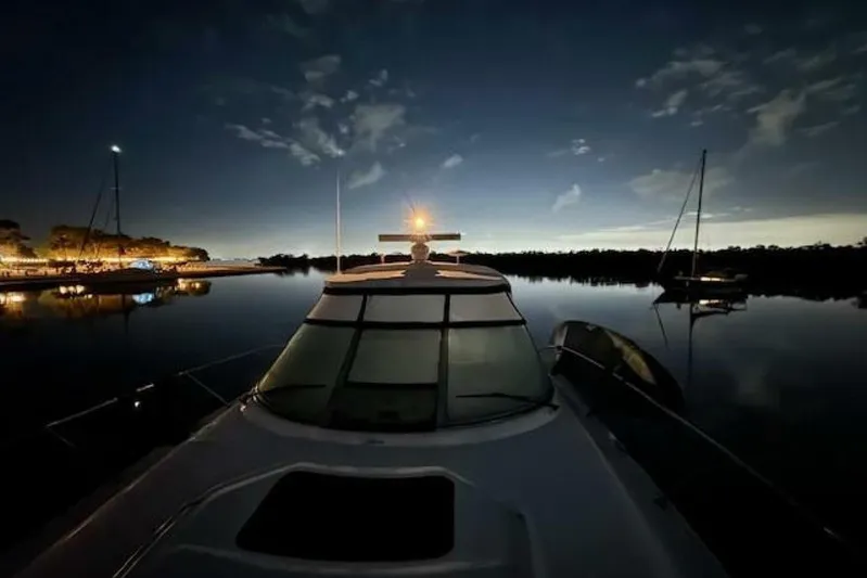  Yacht Photos Pics 2003 Sea Ray 420 Sundancer yacht at night, reflecting on calm water.