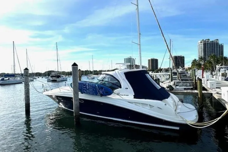  Yacht Photos Pics 2003 Sea Ray 420 Sundancer yacht docked in a marina with city skyline.