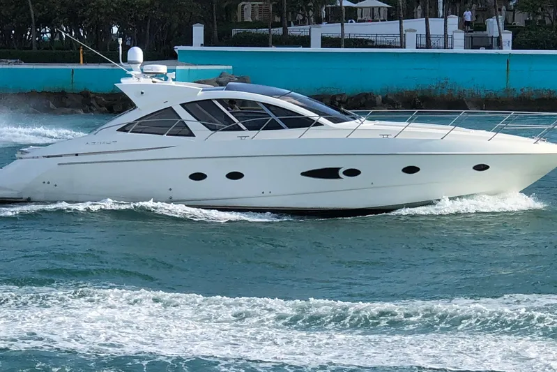 Sol Yacht Photos Pics 2010 Azimut Atlantis 54 yacht cruising on blue water near a turquoise wall.